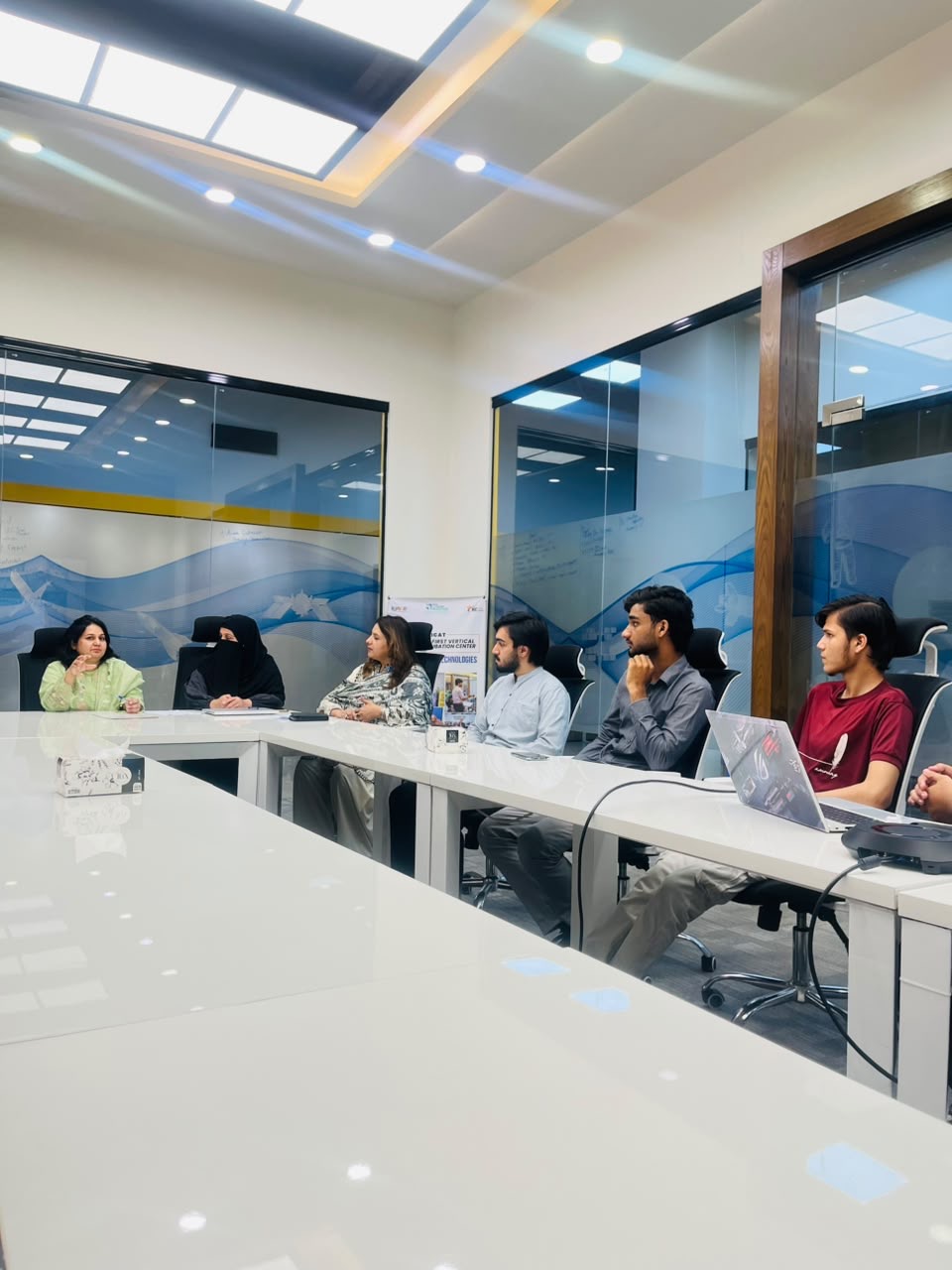 Participants seated around the table in discussion