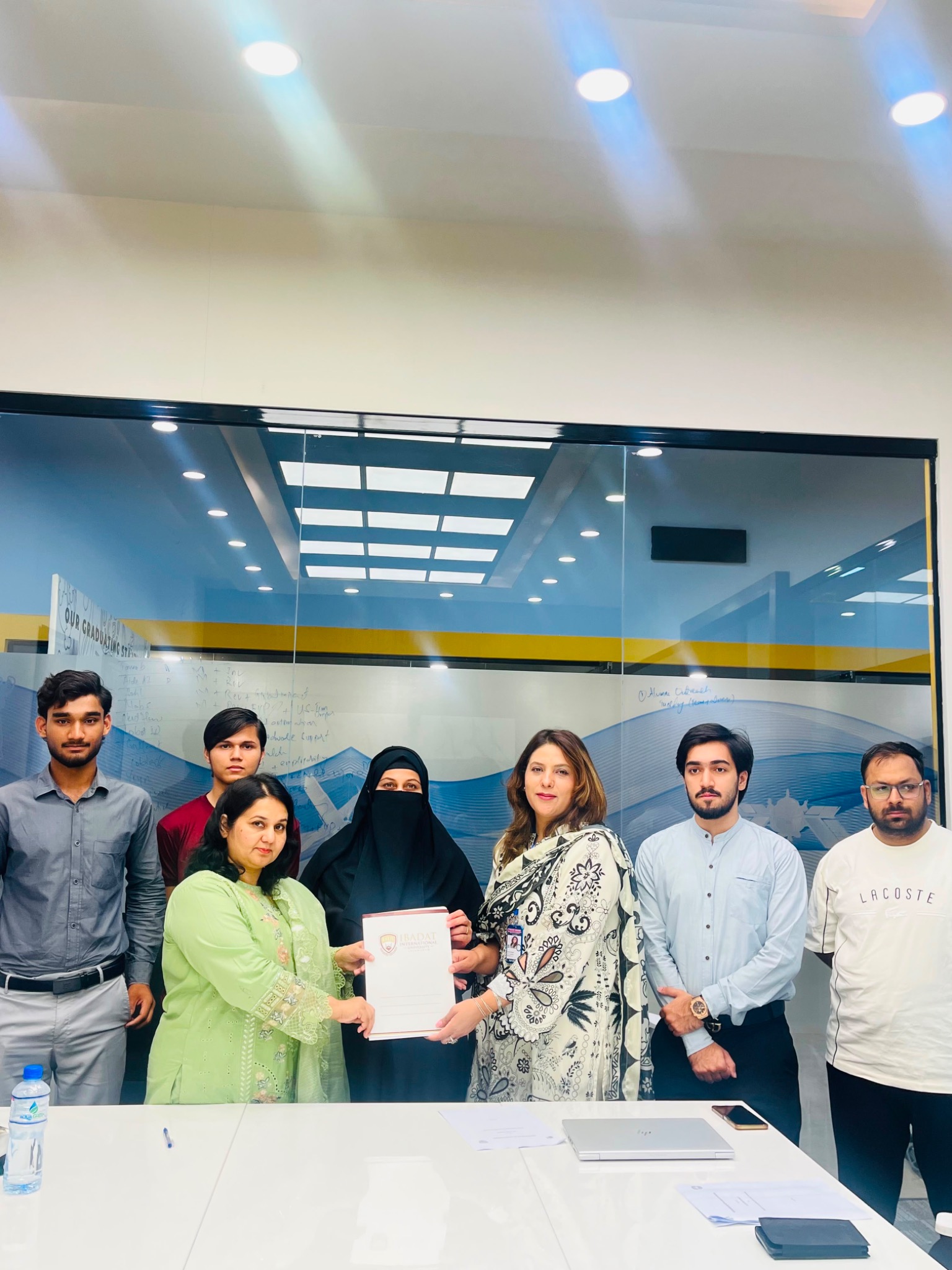 Group photograph holding the MoU at the SM Intern Connect ceremony with Ibadat University